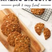 anzac biscuits on a serving board and a wire rack with text overlay "crunchy anzac biscuits".
