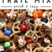 snack mix on a baking tray with text overlay "popcorn trail mix".