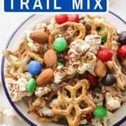 snack mix in a white bowl with text overlay "popcorn trail mix".
