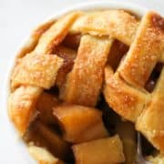 a fork scooping apple pieces from a mini apple pie with text overlay "air fryer apple pies".