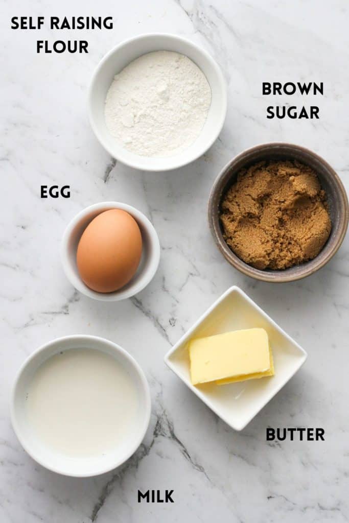 ingredients to make caramel dumplings on a marble background, including egg, butter and milk.