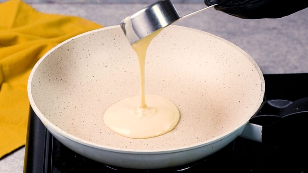 Pouring protein pancake batter on a non-stick pan