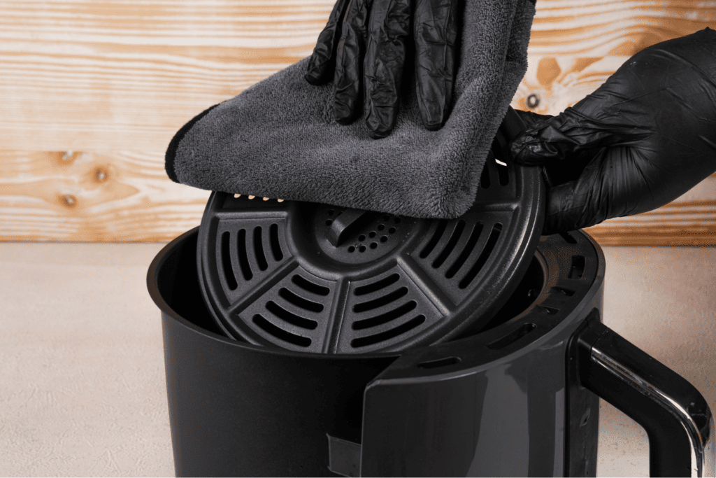 Cleaning air fryer tray with microfiber cloth